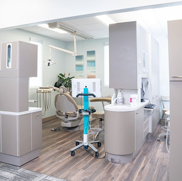Modern dental office interior with treatment chair, equipment, and clinical workspace designed for patient care.