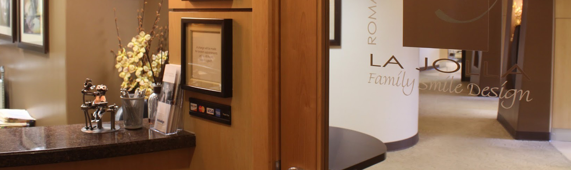 Luxury bathroom showroom displaying elegant vanities, mirrors, and high-end fixtures in warm tones.